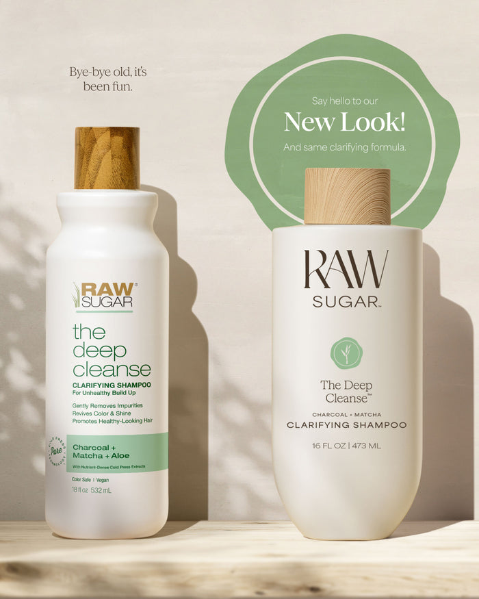 Two bottles of Raw Sugar 'The Deep Cleanse' clarifying shampoo on a wooden surface with a beige background.