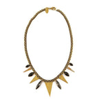 Gold chain necklace with black gemstone accents and triangular brass pendants.
