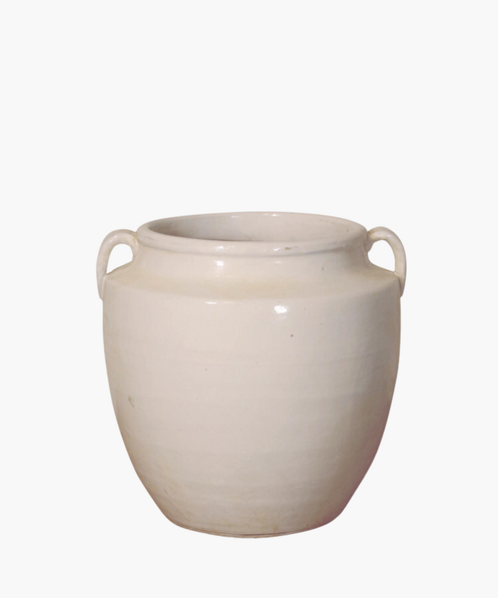 White ceramic pot with two small handles on each side. The smooth, glossy surface and wide opening give a simple, elegant appearance. | Wildwood Home Co.