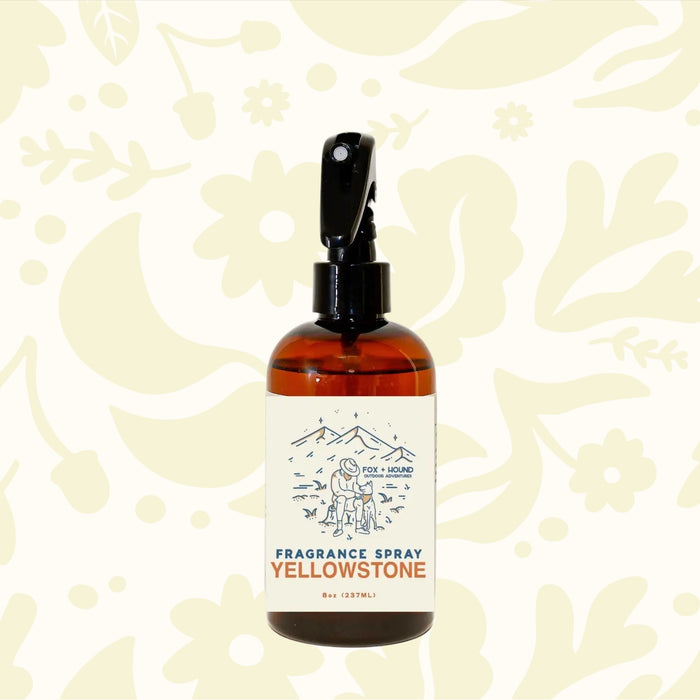 A brown bottle of Fox + Hound Dog Cologne - Yellowstone with a black sprayer and an illustration on the label, part of the Outdoor Adventures Collection.
