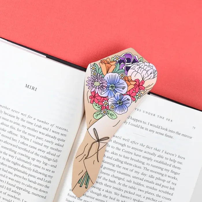 Die cut paper flower bouquet bookmark on open book, red background—unique Humdrum design perfect for book lovers and gifts.