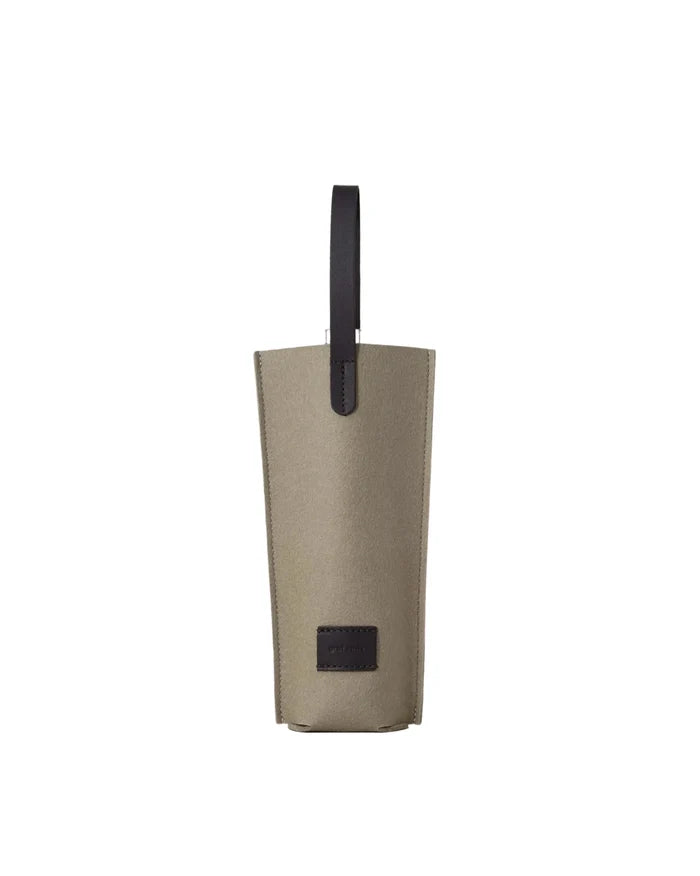 Beige bag with a black handle on a light beige background