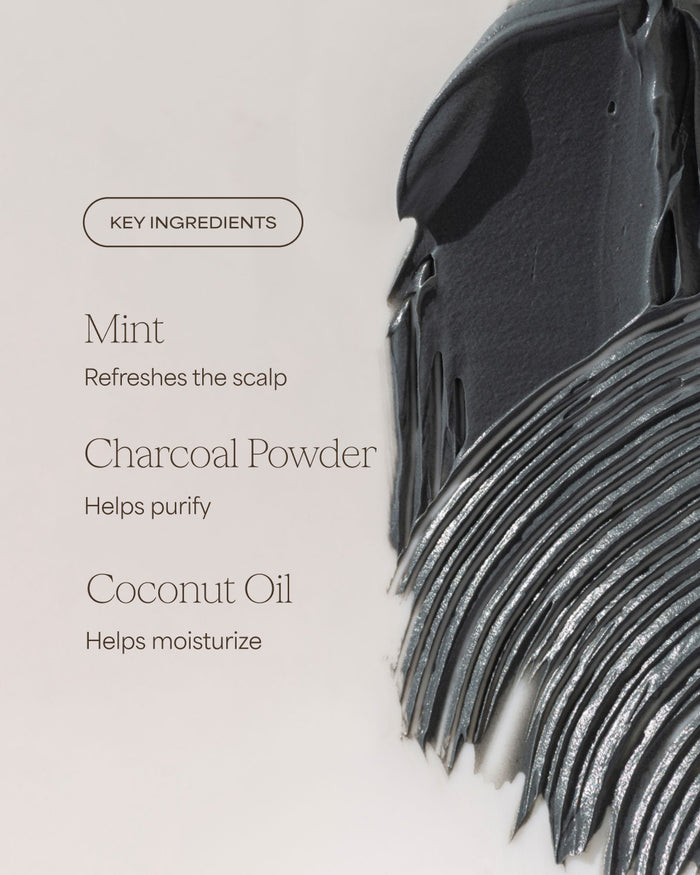 Black hairbrush with key ingredients listed on a light gray background
