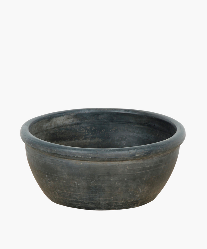 A large, shallow, grey black bowl with a smooth finish and subtle textures. The bowl conveys a rustic feel. | Wildwood Home Co.